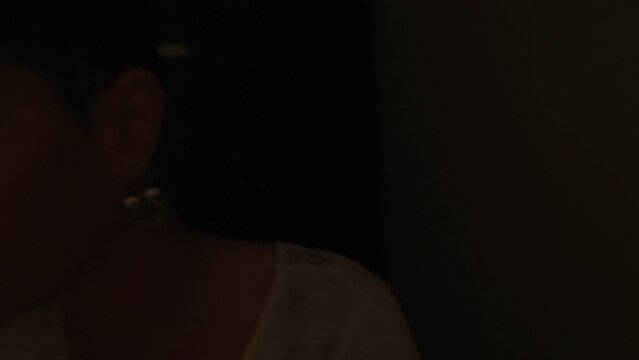 drunk woman who can barely stand up groping along the corridor