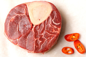 Raw steak on baking paper in the kitchen