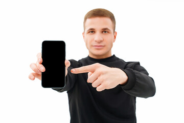 a man in black clothes shows the screen of a smartphone on a white background.