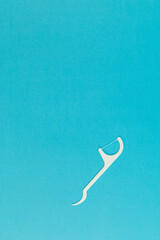 Floss with plastic handle on blue background