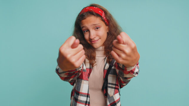 Greedy angry teenager child girl kid showing fig negative gesture, you dont get it anyway. Rapacious, avaricious, acquisitive. Body language. Refusal fig sign. Preteen children on blue background