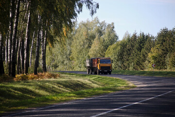 A sharp turn, a beautiful country road with a truck far