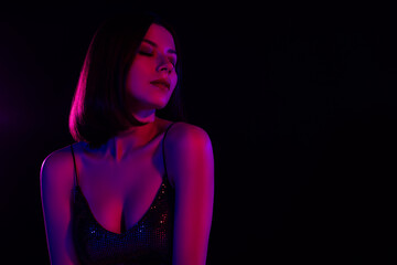 Fototapeta premium Full of tenderness stunning woman close her eyes enjoy music rhythms nigh club stylish lights colorful background
