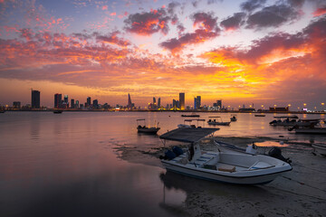 A beautiful panoramic view of Bahrain skyline with dramatic clouds after sunset.