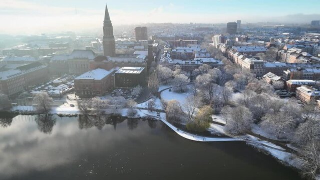 Aerial footage of Kiel in winter. Spire of town hall  and TV Tower of Kiel in winter. Snow in Kiel. Advent, Christmas market near town hall.