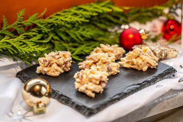Almond slivers with white chocolate on a slate with Christmas decorations