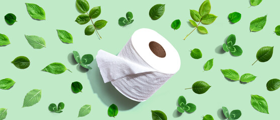 A roll of toilet paper with green leaves - flat lay - obrazy, fototapety, plakaty
