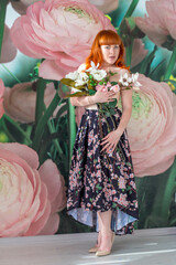 girl with a bouquet of magnolias. the girl covers her Breasts with flowers. red-haired girl