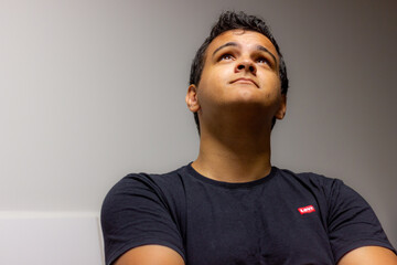 Young guy top looking thinking about latin american wondering meditate