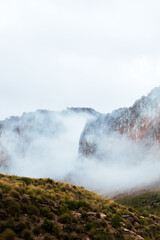 Clouds passing between the mountains