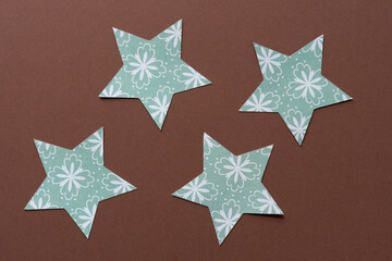 fancy green paper stars on brown paper
