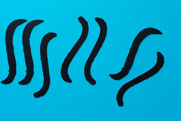 abstract black paper shapes on blue