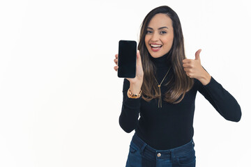 Fototapeta premium young cheerful woman in casual clothes holding a phone with black screen and showing ok sign with another hand, copy space medium shot isolated. High quality photo