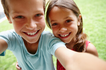 Sibling selfie. Shot of a young brother and sister taking a selfie in the garden.