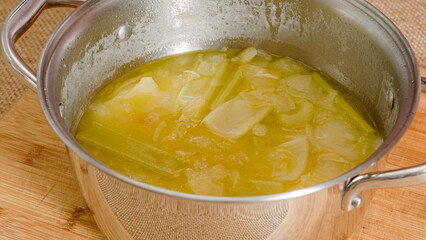 Cooking pan with boiled vegetables close-up. Creamy pureed celery soup recipe