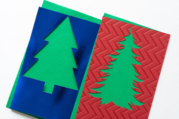 two stencils with tree shape cutouts on white