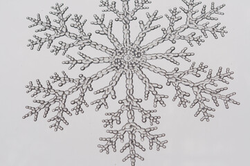 plastic snowflake and grungy window on a snowy day