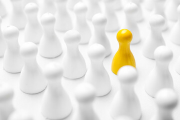 Yellow pawn among others on white background, closeup. Recruiter searching employee