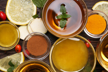 Flat lay composition of tea with honey and ingredients on wooden table