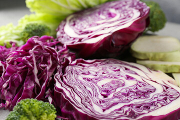 Different types of cut cabbage on table, closeup