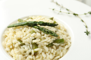 Delicious risotto with asparagus in plate, closeup