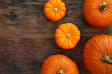 Fresh ripe pumpkins on wooden table, flat lay. Space for text