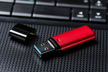Modern usb flash drive on laptop, closeup