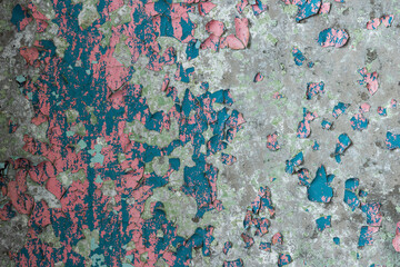 Peeling paint on the wall. Old concrete wall with cracked flaking paint. Weathered rough painted surface with patterns of cracks and peeling. Grunge texture for background and design. High resolution.