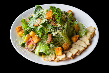 Caesar salad served in Vietnamese style on black background side view