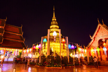 Naklejka na ściany i meble Phra That Hariphunchai Temple during Lamphun Saen Duang Lantern Festival in Lamphun Province