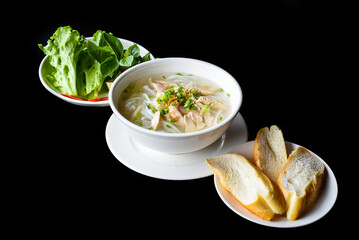 Traditional vietnamese soup Pho ga with chicken on black background