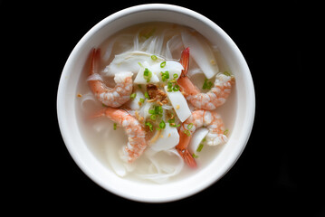 Traditional vietnamese soup Pho with seafood on black background
