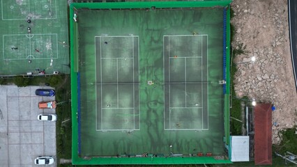 aerial view of two green  tennis courts