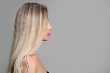 woman with straight blond hair. face in profile