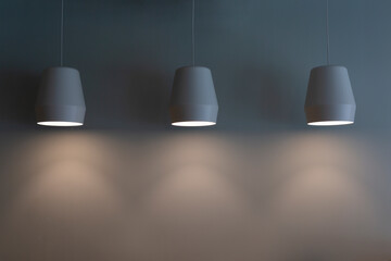 lamps hang on a gray wall