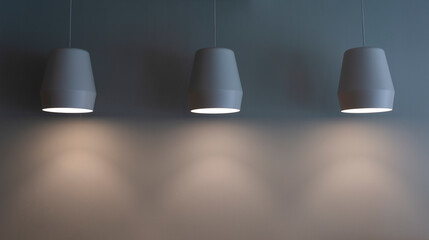 lamps hang on a gray wall