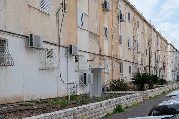 typical old aged Architecture in israel. Old buildings with air conditioners and plumber waste pipe systems on the wall.