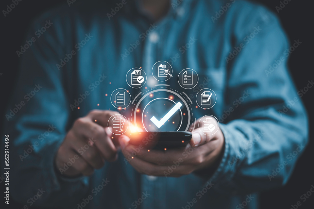 Poster Businessman using smartphone and  virtual correct sign or tick mark with document icon for approve quality assurance and guarantee concept.