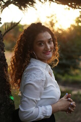 girl with curly hair posing in golden light