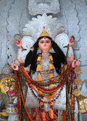 A gorgeous looking divine idol of Hindu Goddess Jagatdhatri / Jagaddhatri inside puja pandal. Shot at Chandannagar, West Bengal where it is a major religious festival.