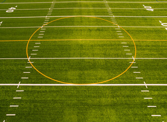 Soccer field top straight down aerial shot. Empty football playground. Sport stadium green grass and white paint lines and marks for games and activity. Healthy lifestyle.