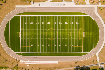 Top view of empty soccer field without players. Football field with grass and white paint lines and marks. Sports soccer and football with green surface. Recreational activity. © desertsands
