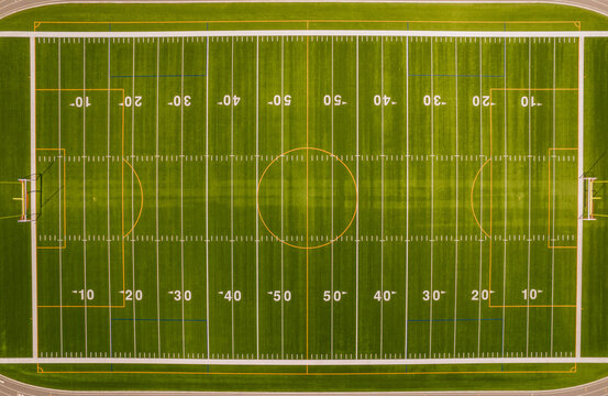 Soccer field top straight down aerial shot. Empty football playground. Sport stadium green grass and white paint lines and marks for games and activity. Healthy lifestyle.