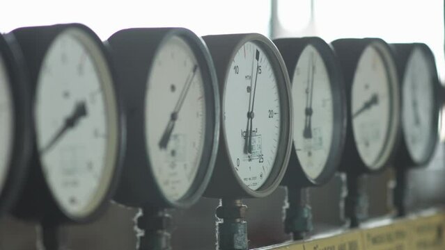 Multiple Manometers measure system pressure in a production facility. Pressure gauges monitor system pressure in production