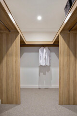 Fototapeta na wymiar new stylish modern Walk in robe with two white business shirts hanging 