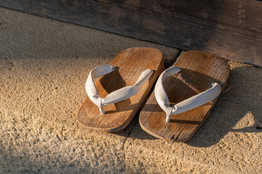 Traditional Japanese wooden sandals in front of the door. Japan.