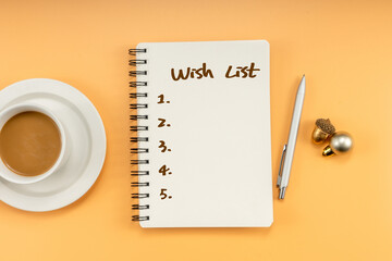 Wish list writting on notepad with Christmas decorations. Christmas mock up template. View from above.