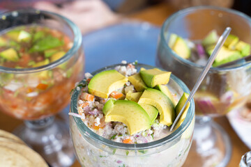 Mexican ceviche cocktail glasses with avocado. Traditional seafood appetizer in Mexico