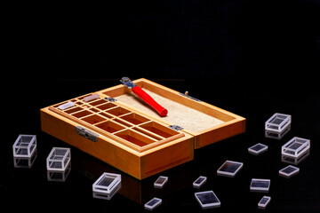 manual glass cutter, diamond-coated cutting roller, on a black background with glass figures.