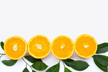 Orange fruit with green leaves on white background.